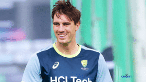 Australian cricketer Pat Cummins smiling in team training gear.