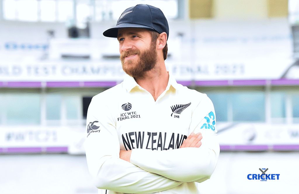 NZ cricket player Williamson in cricket stadium, smiling, wearing team jersey and cap.
