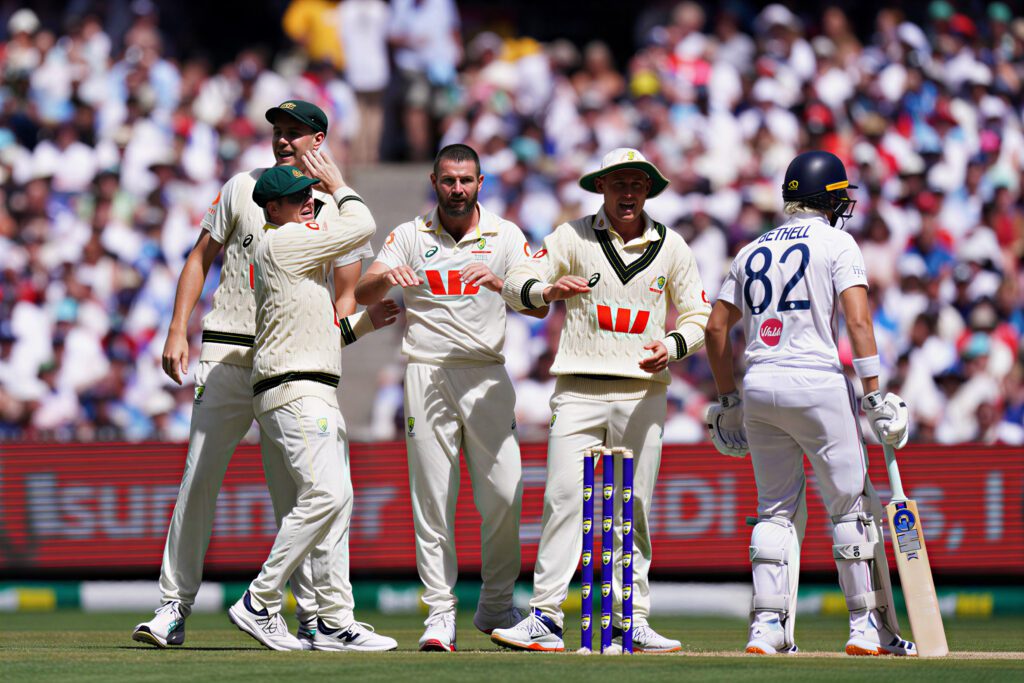 Celebrating a key moment in the Ashes series with players rejoicing on the field.
