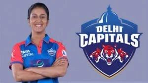 Delhi Capitals cricket player smiling with team logo in background.