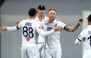 English cricket players celebrating on the field during Ashes 2025-26 match.