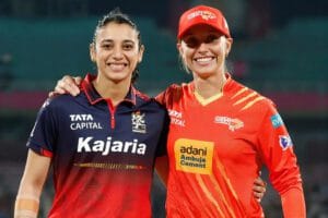 RCB women cricketers smiling after winning against Gujarat Giants in Vadodara.