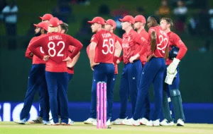 England cricket team huddles during a match, focusing on teamwork and strategy.